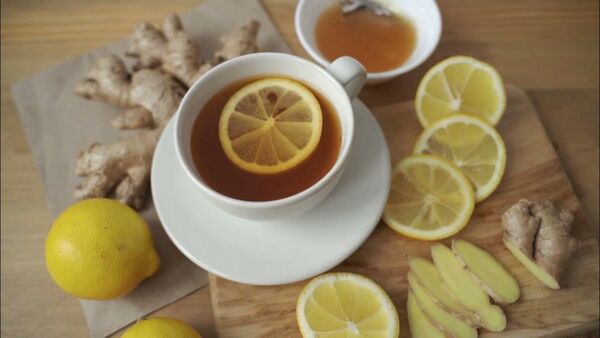Fresh ginger and lemon on a board for a warm morning cup